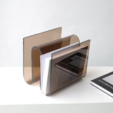 Archive smoke acrylic magazine holder by BAG&BONES styled with coffee table books on a modern shelf.
