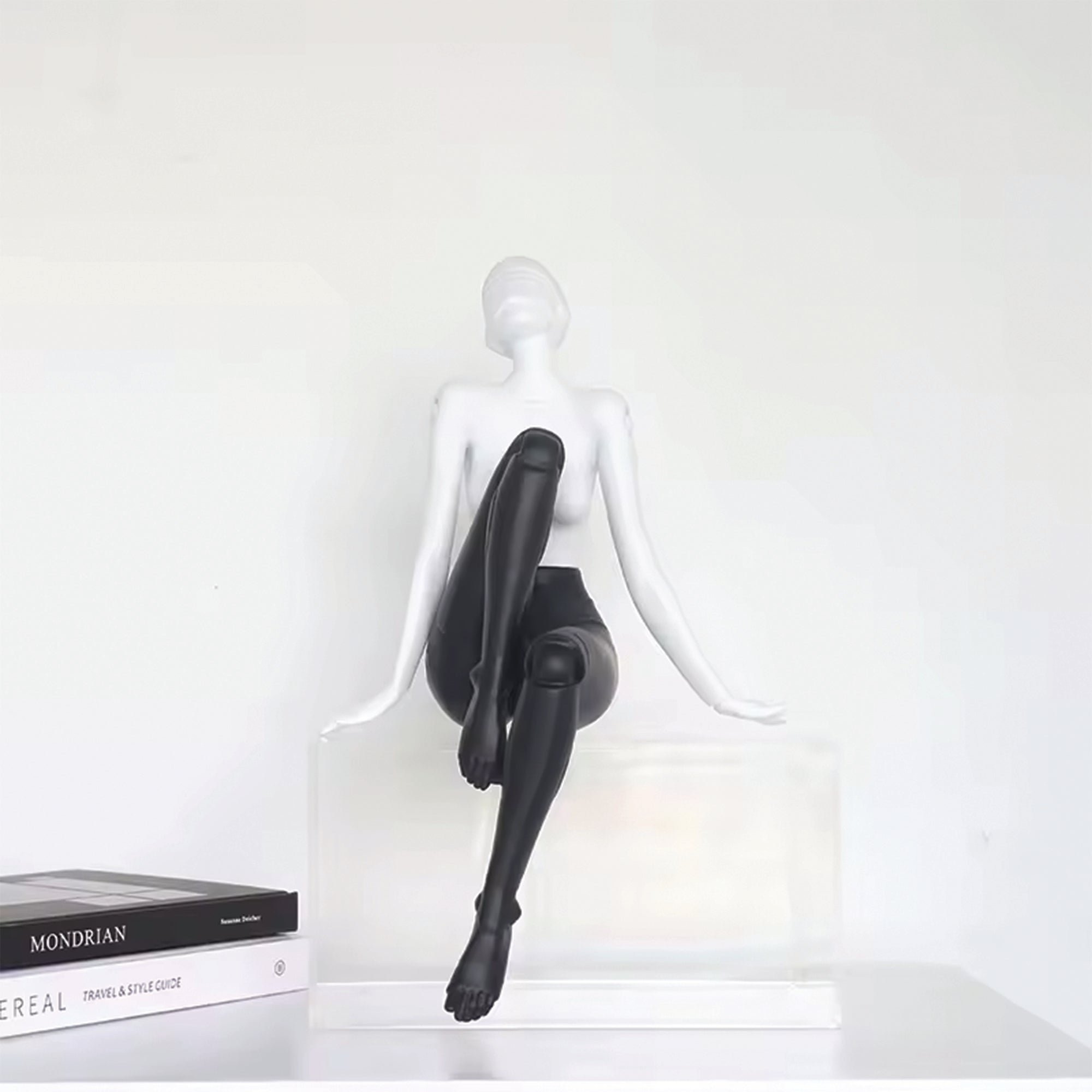 Odette contemporary figure sculpture by BAG&BONES styled on a tabletop, featuring a monochrome seated female form with a modern sculptural design.