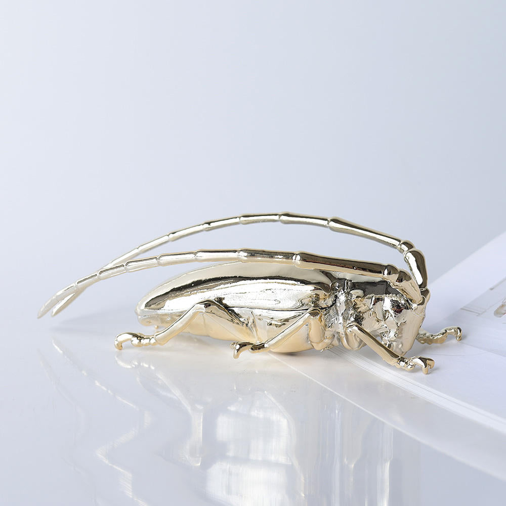 Scarab decorative beetle sculpture by BAG&BONES featuring a polished gold finish, styled on a tabletop in a contemporary interior.