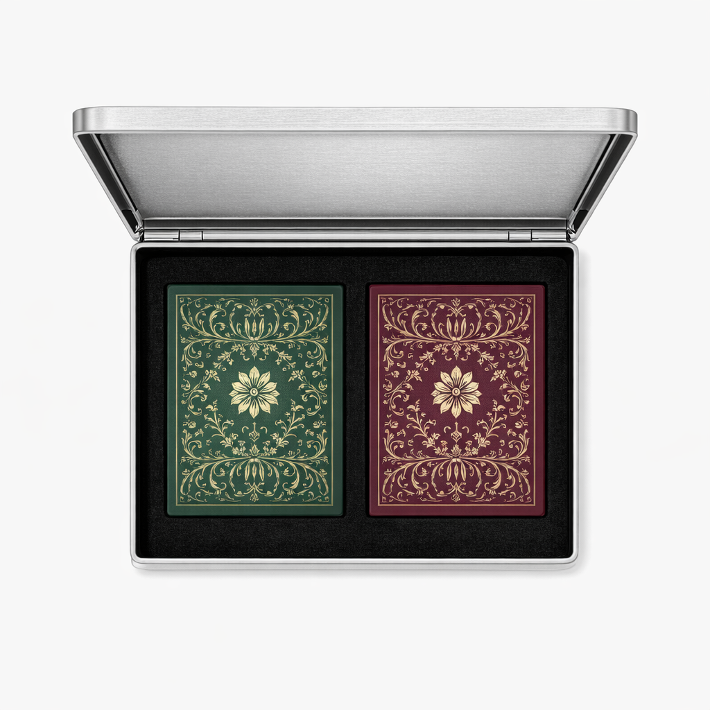 Open brushed silver playing card case with two ornate green and burgundy card decks set into black foam.