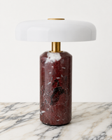 Design-led Muse table lamp featuring a red violet marble base, brass detailing and a glossy white