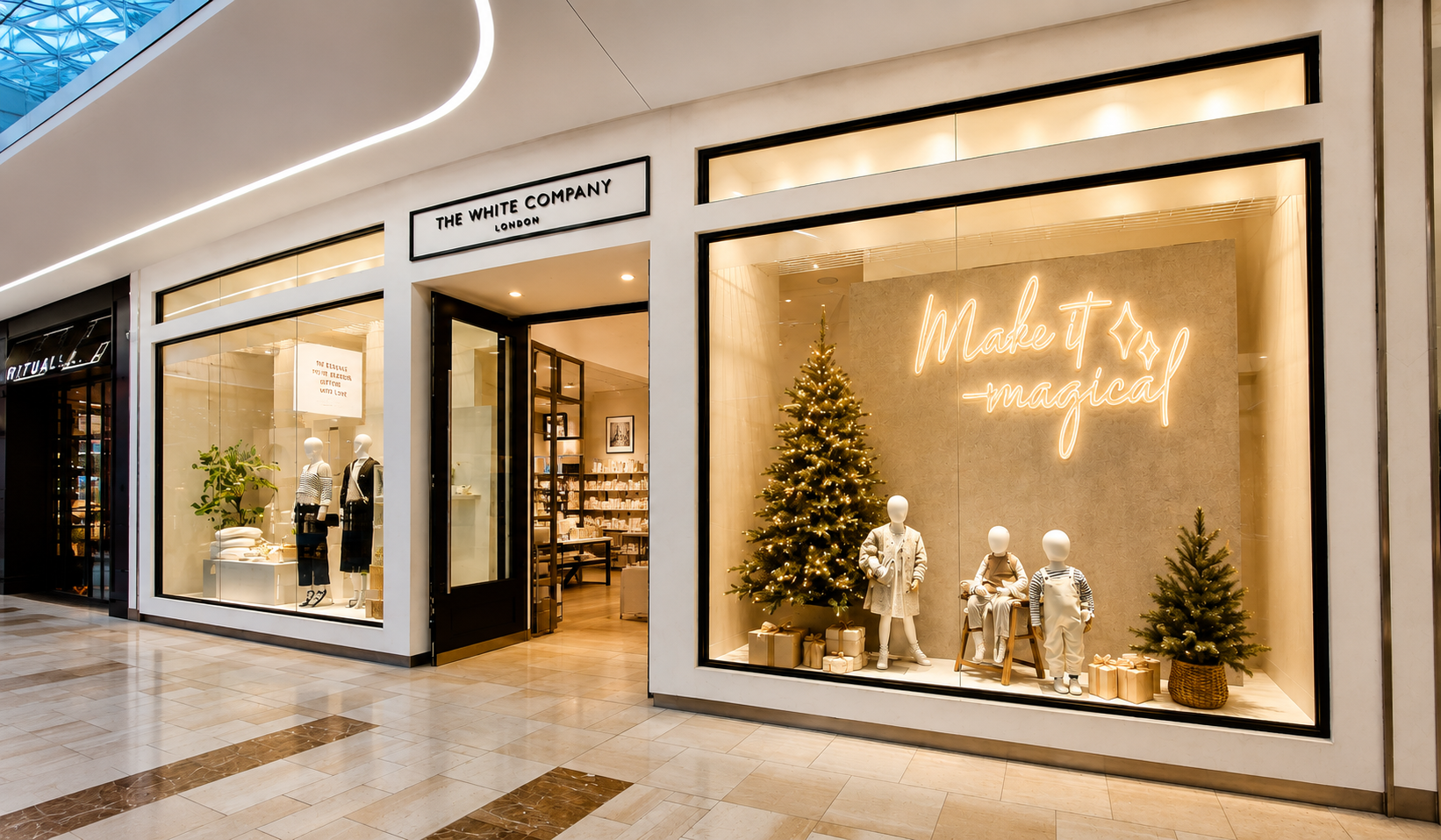 The White Company Christmas window display with bespoke warm-white handwritten neon signage