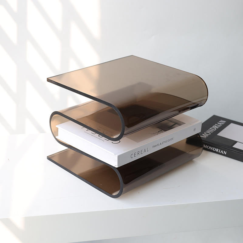 Archive smoke acrylic book stand by BAG&BONES displaying a coffee table book on a contemporary shelf.