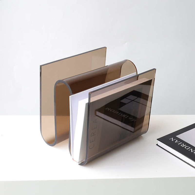 Archive smoke acrylic magazine holder by BAG&BONES styled with coffee table books on a modern shelf.