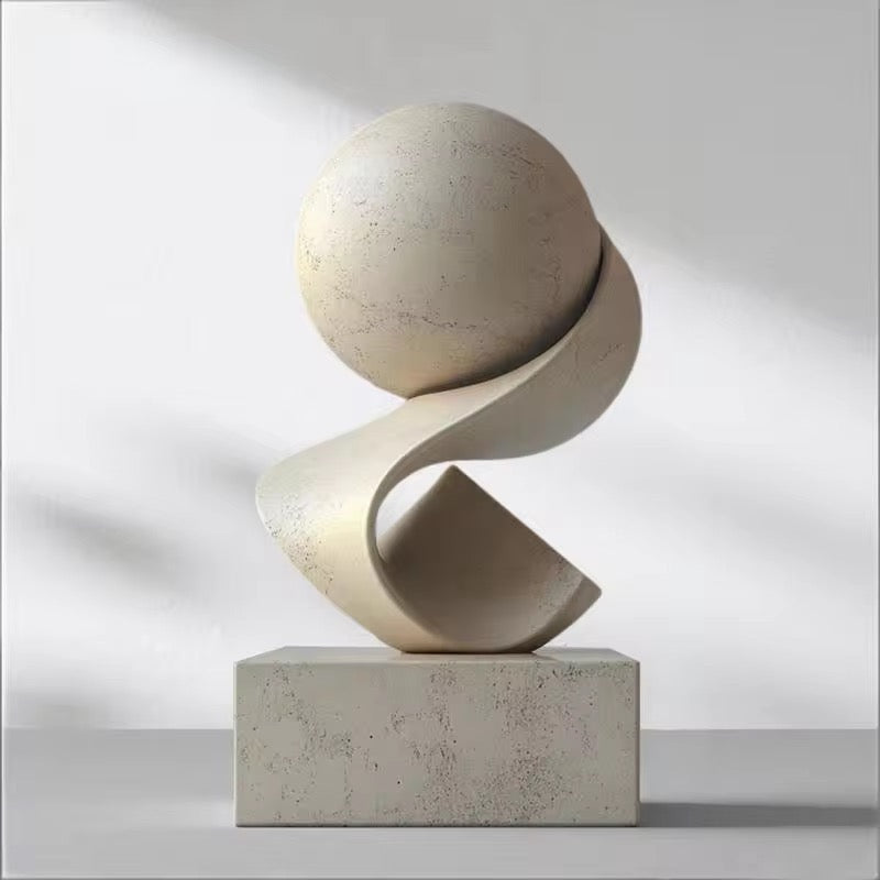 Equilibrium abstract decorative sculpture by BAG&BONES styled in a contemporary interior, featuring a textured stone-effect sphere balanced on a sculptural curved form.