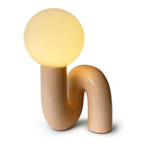 The Pink Lune Lamp sculptural table lamp with curved pink resin base and warm white glass globe