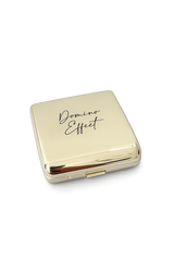 Polished gold domino case with “Domino Effect” etched on the lid, compact luxury domino set closed