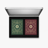 Open brushed silver playing card case with two ornate green and burgundy card decks set into black foam.