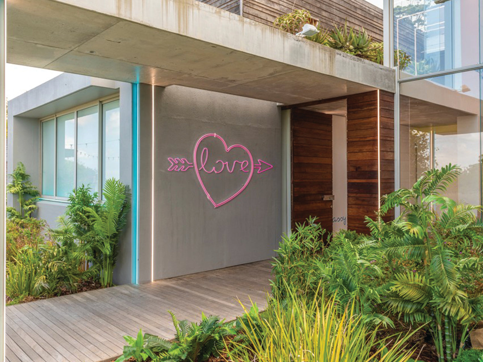 Love Island villa featuring BAG&BONES LED neon signs