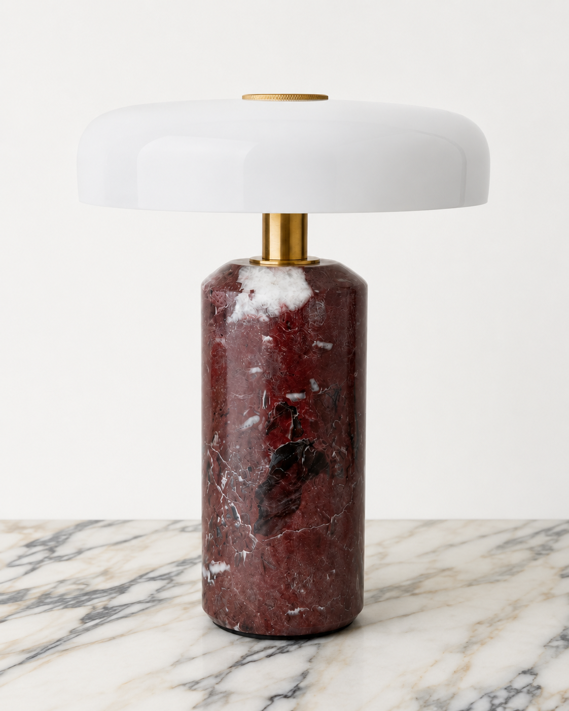Design-led Muse table lamp featuring a red violet marble base, brass detailing and a glossy white