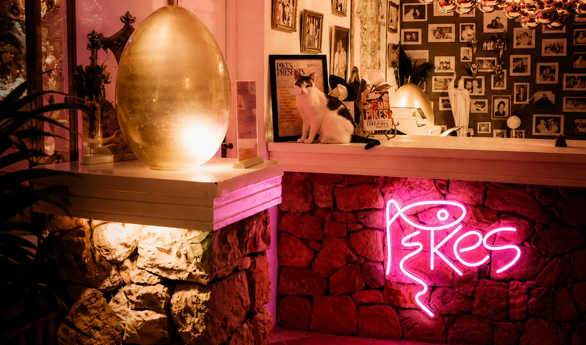 Pink Pikes neon sign fitted into the reception desk at Pikes Hotel Ibiza