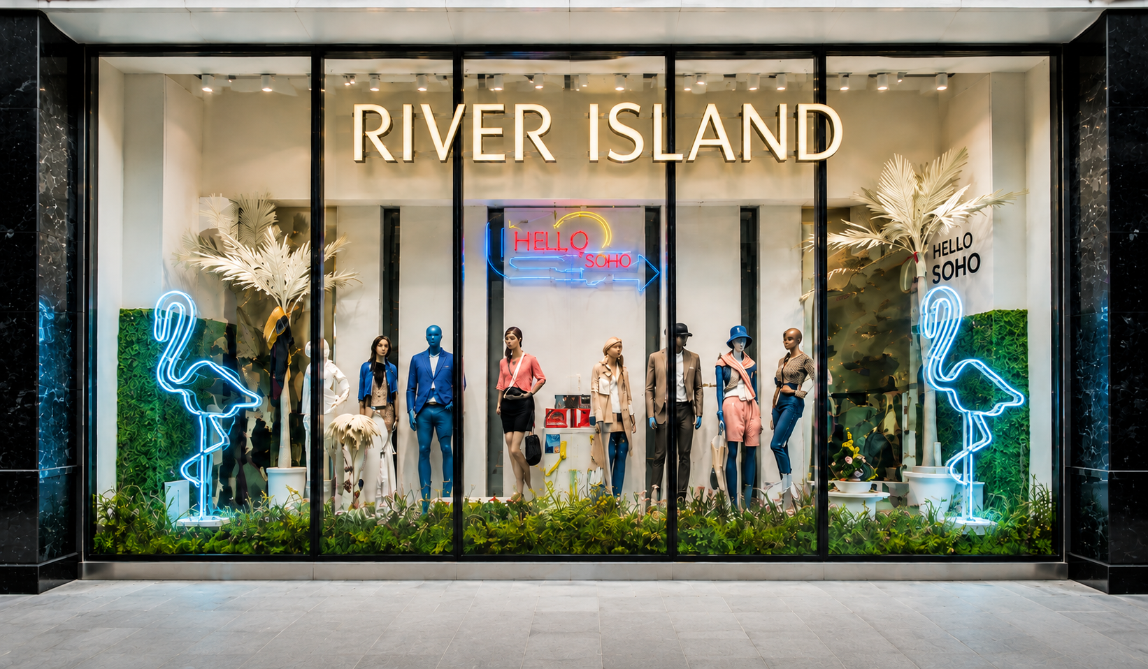 River Island shop window display featuring oversized blue neon flamingos